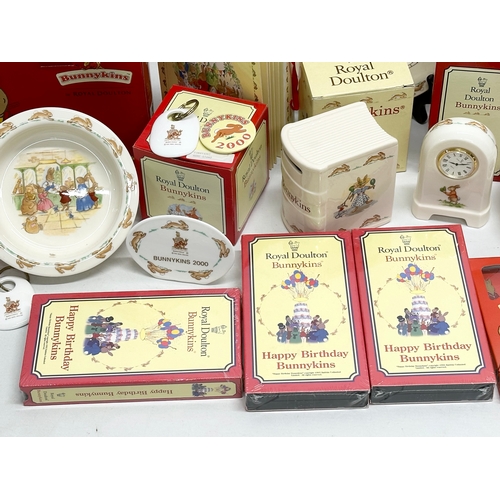 906 - A collection of Royal Doulton Bunnykins. Plates, clocks, money banks, key rings, cups etc