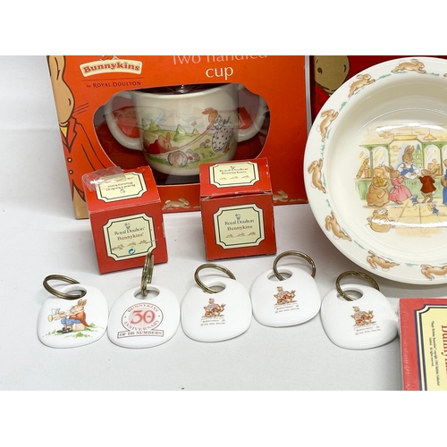 906 - A collection of Royal Doulton Bunnykins. Plates, clocks, money banks, key rings, cups etc