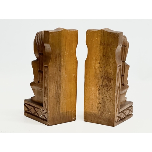 536 - A pair of Mid 20th Century Tiki Monkeypod bookends. 19.5cm.