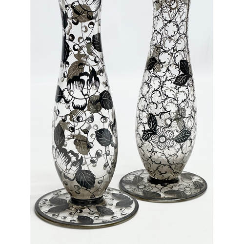 157 - A near pair of Early 20th Century glass vases with hand painted silver overlay. 23cm