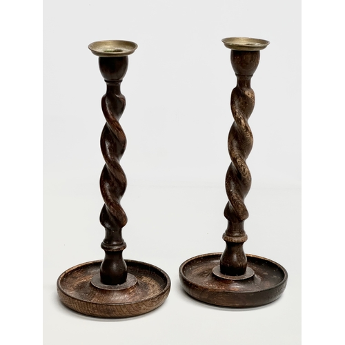 149 - A pair of tall Early 20th Century oak barley twist candlesticks. Circa 1900-1920. 32cm