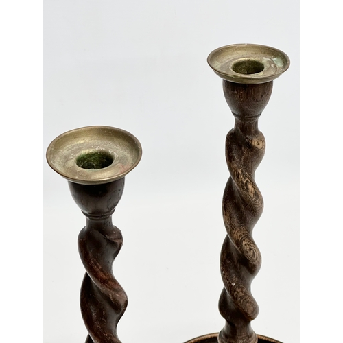 149 - A pair of tall Early 20th Century oak barley twist candlesticks. Circa 1900-1920. 32cm