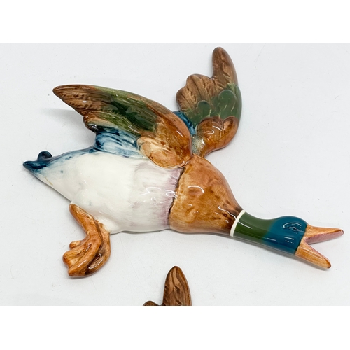 557 - Two large Mid Century pottery ducks by Bewick. 27x26cm.