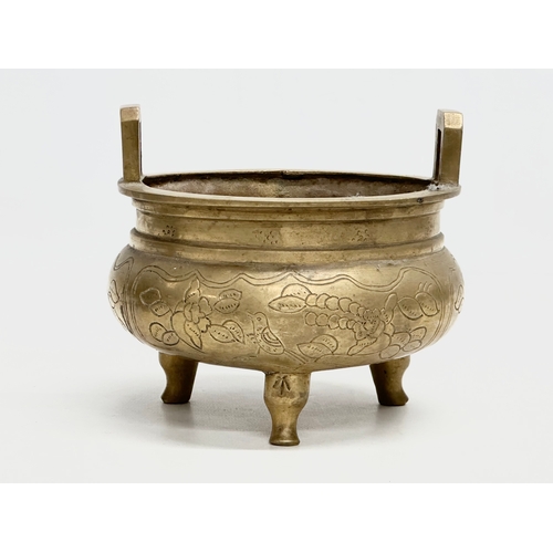 77 - A 19th Century Chinese engraved brass tripod censor/incense burner. Emperor Xuande mark. 15x15x13cm.