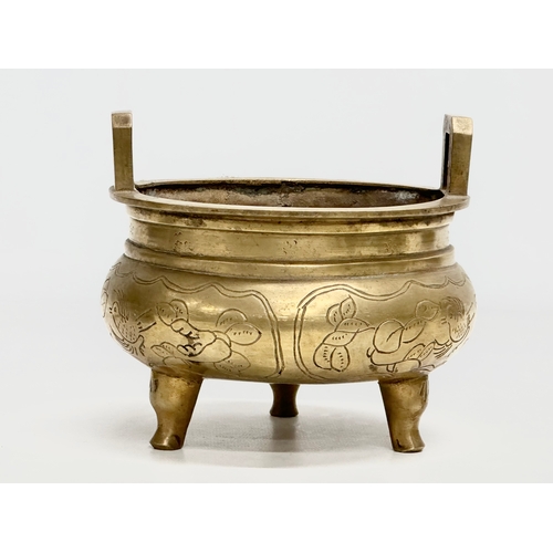 77 - A 19th Century Chinese engraved brass tripod censor/incense burner. Emperor Xuande mark. 15x15x13cm.