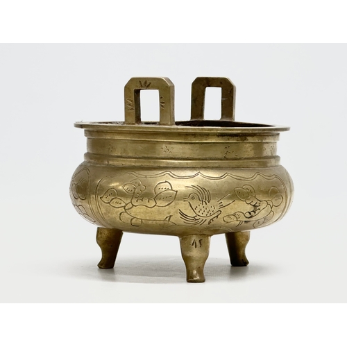 77 - A 19th Century Chinese engraved brass tripod censor/incense burner. Emperor Xuande mark. 15x15x13cm.