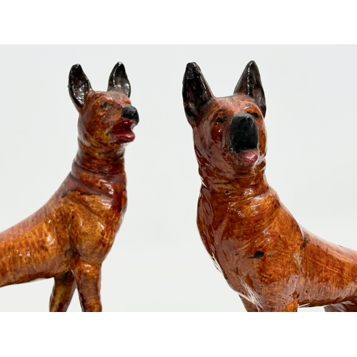 203 - A pair of Early 20th Century German Shepherds. 14x24cm.