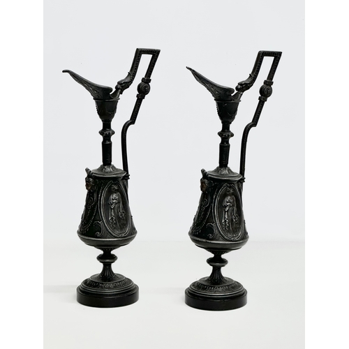 167 - A pair of Late 19th Century French cast iron ewer style garnitures on slate bases. 32.5cm.