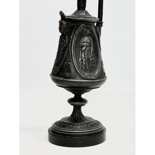 167 - A pair of Late 19th Century French cast iron ewer style garnitures on slate bases. 32.5cm.