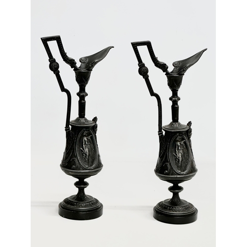 167 - A pair of Late 19th Century French cast iron ewer style garnitures on slate bases. 32.5cm.