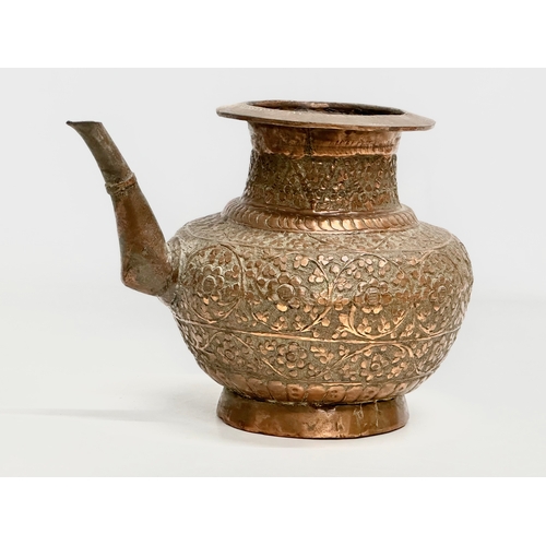 85 - A 19th Century Indian embossed copper holy water vessel and cup. 24x17x18cm.