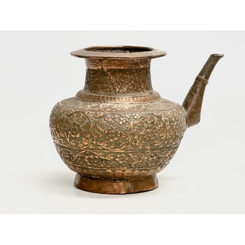 85 - A 19th Century Indian embossed copper holy water vessel and cup. 24x17x18cm.