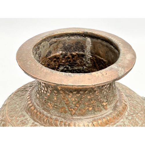 85 - A 19th Century Indian embossed copper holy water vessel and cup. 24x17x18cm.