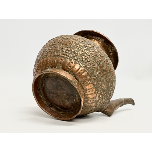 85 - A 19th Century Indian embossed copper holy water vessel and cup. 24x17x18cm.