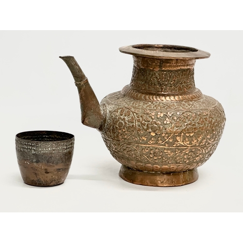 85 - A 19th Century Indian embossed copper holy water vessel and cup. 24x17x18cm.