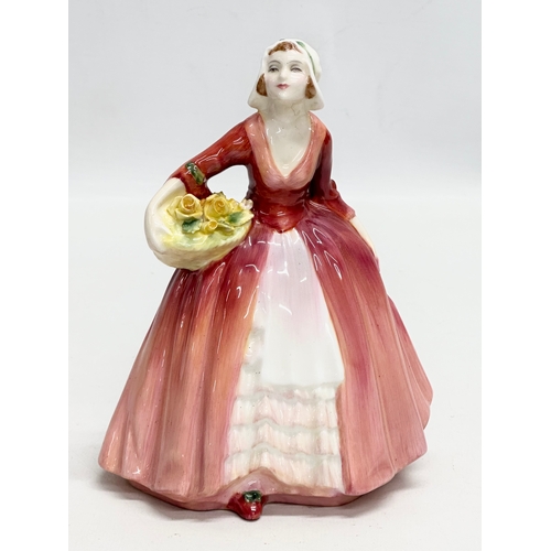 907 - Three Royal Doulton figurines. A Royal Doulton “Janet” figurine, copr 1932, HN1537. A Royal Doulton ... 