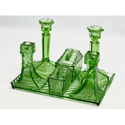 564 - A 1930’s Art Deco uranium glass dressing table set. Tray 30x20cm.