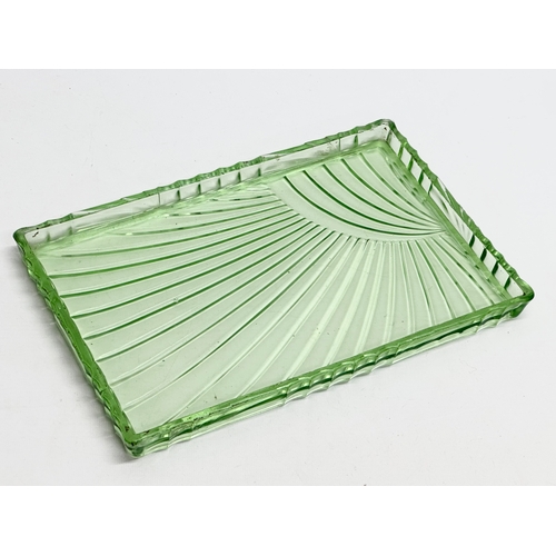 564 - A 1930’s Art Deco uranium glass dressing table set. Tray 30x20cm.