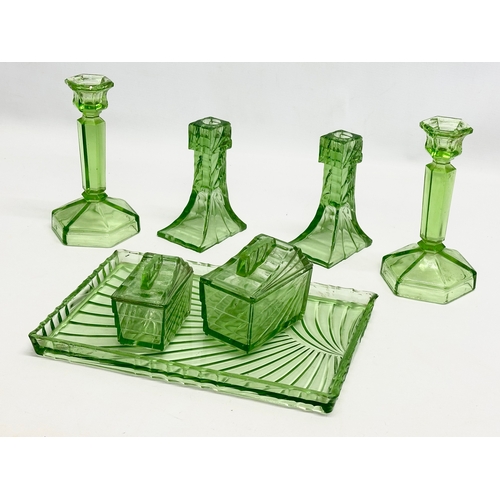 564 - A 1930’s Art Deco uranium glass dressing table set. Tray 30x20cm.