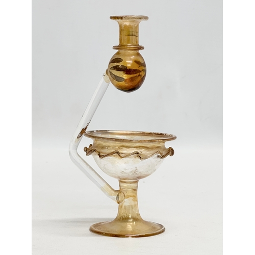 696 - An iridescent art glass oil lamp. 15cm