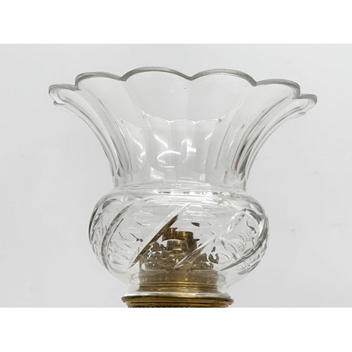 31 - A Late 19th/Early 20th Century glass oil lamp. With multi coloured art glass column. 39cm