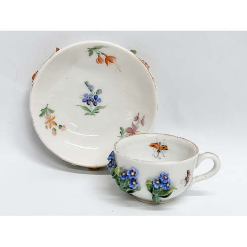 20 - A Late 19th/Early 20th Century, Sitzendorf miniature cup and saucer. Hand painted, with encrusted fl... 