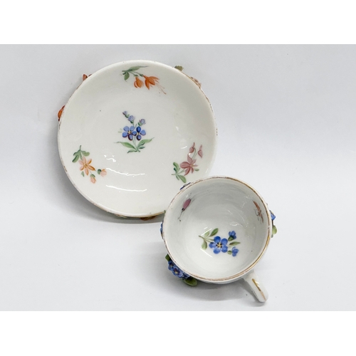 20 - A Late 19th/Early 20th Century, Sitzendorf miniature cup and saucer. Hand painted, with encrusted fl... 