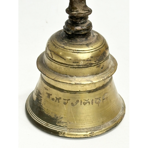 215 - A 19th Century brass Hanuman bell. 21cm