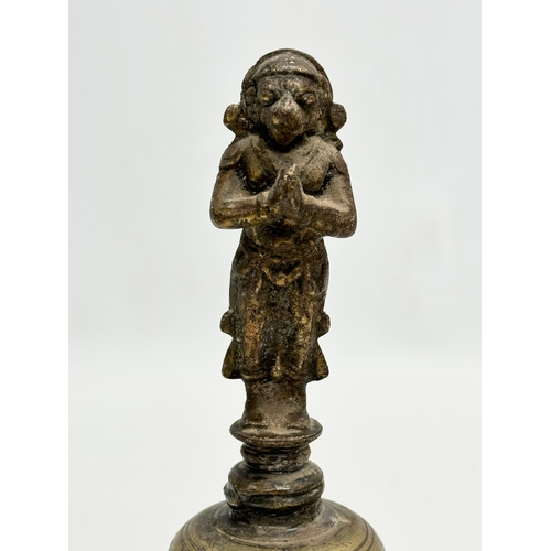 215 - A 19th Century brass Hanuman bell. 21cm