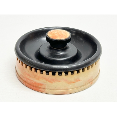 114 - An Art Deco Bakelite ashtray match striker. By Roanoid for Roxon. 13x6cm.