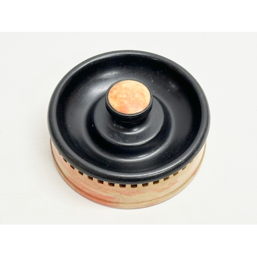 114 - An Art Deco Bakelite ashtray match striker. By Roanoid for Roxon. 13x6cm.