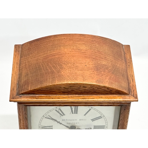 238 - Beringer Bros, Belfast. A Late 19th Century inlaid oak cased mantle clock. By Beringer Bros. With ke... 