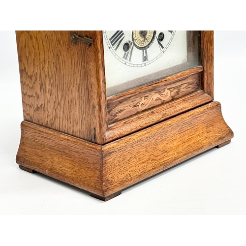 238 - Beringer Bros, Belfast. A Late 19th Century inlaid oak cased mantle clock. By Beringer Bros. With ke... 