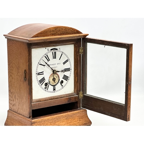 238 - Beringer Bros, Belfast. A Late 19th Century inlaid oak cased mantle clock. By Beringer Bros. With ke... 