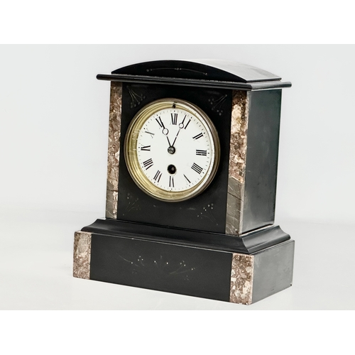 239 - A Late 19th Century Victorian slate mantle clock. With key and pendulum. 21x12x25cm.