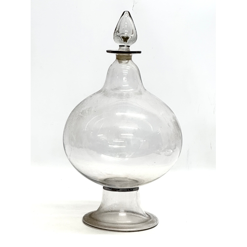 266 - A large Mid 19th Century glass apothecary chemist jar with stopper. 21x40cm