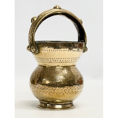 361 - An Early 20th Century Indian brass holy water vessel. 23cm.