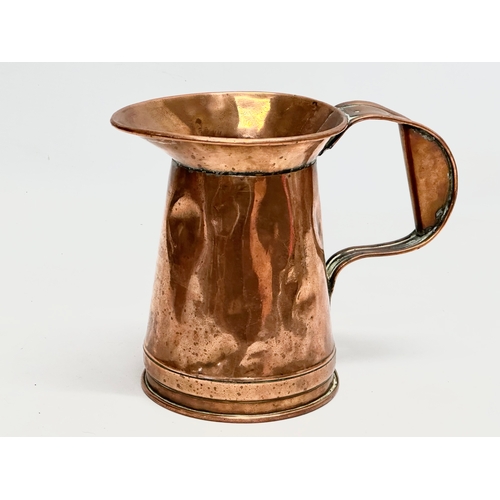 610 - A Victorian copper jug. 22x18cm