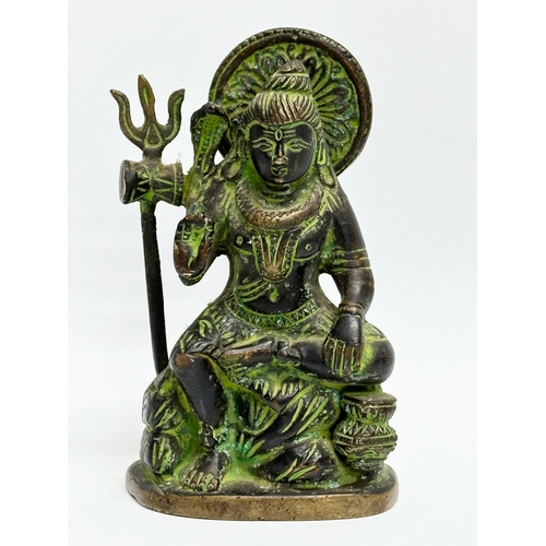 915 - A small Early 20th Century bronze Hindu sitting Shiva statue. 12cm