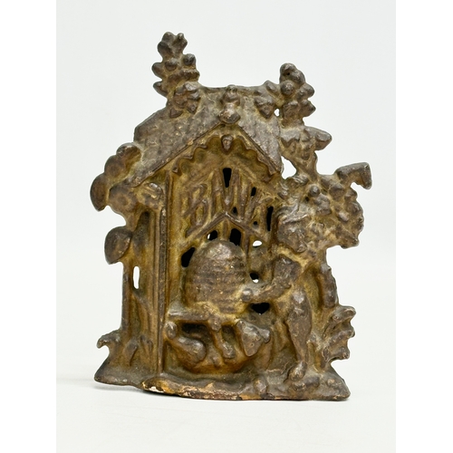 395 - A 19th Century Victorian cast iron “Bear and Honey” money box. 10x5x14cm.