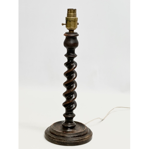 618 - A 1920’s oak barley twist table lamp. 37cm