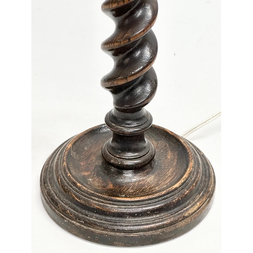 618 - A 1920’s oak barley twist table lamp. 37cm