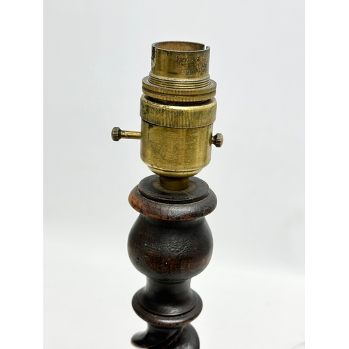 618 - A 1920’s oak barley twist table lamp. 37cm