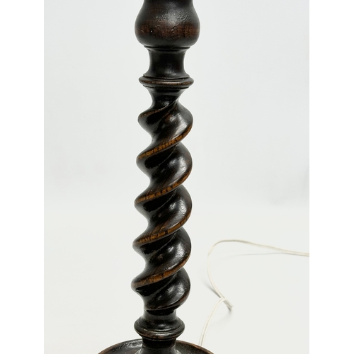 618 - A 1920’s oak barley twist table lamp. 37cm