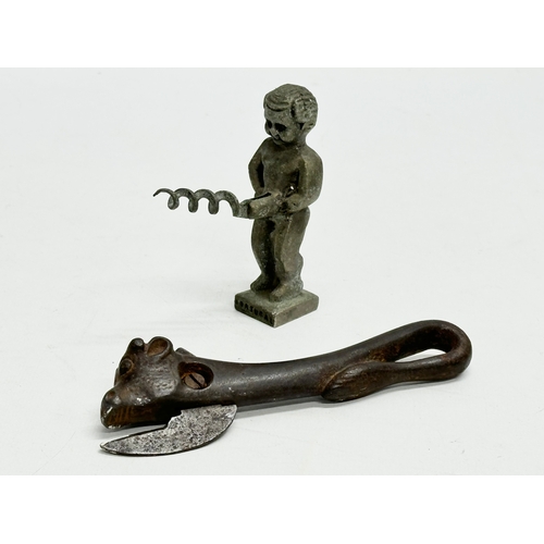 614 - A 19th Century bullhead tin opener. Together with a novelty corkscrew.