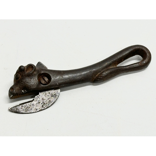 614 - A 19th Century bullhead tin opener. Together with a novelty corkscrew.