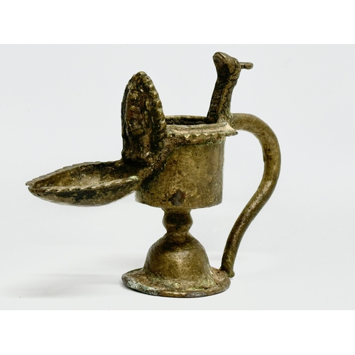 232 - A 19th Century bronze Sukunda lamp/oil lamp. 13x10cm