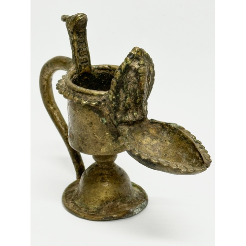 232 - A 19th Century bronze Sukunda lamp/oil lamp. 13x10cm