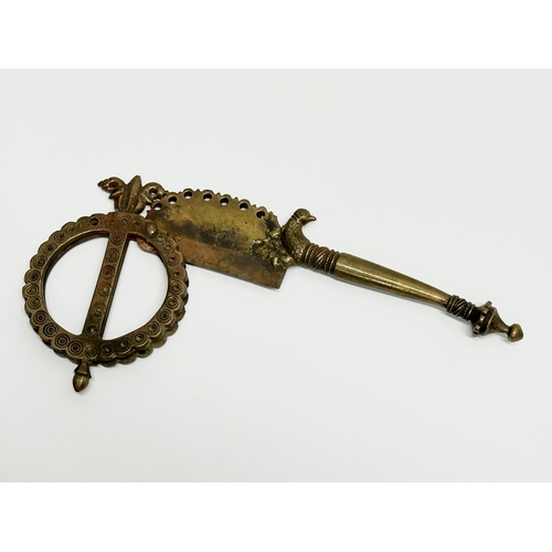 515A - A 19th Century Indian brass betel cutter. 19cm