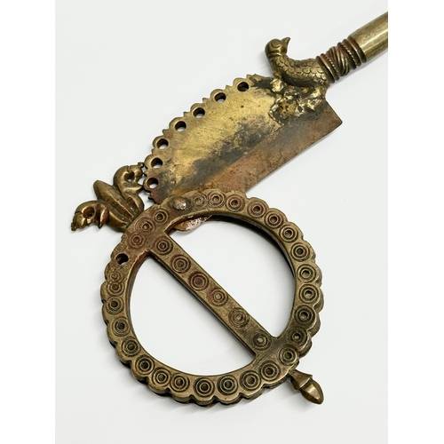 515A - A 19th Century Indian brass betel cutter. 19cm